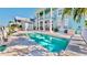 Relaxing pool and deck area with a view of the charming exterior of the waterfront home at 615 Islebay Dr, Apollo Beach, FL 33572