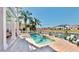 Beautiful in-ground swimming pool with a water view and lush landscaping at 615 Islebay Dr, Apollo Beach, FL 33572