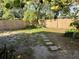 Large backyard with green grass, a fence, and a stepping stone path at 624 Folsom S St, St Petersburg, FL 33707