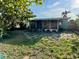 Exterior view of the house from the spacious backyard with fence and sunroom at 624 Folsom S St, St Petersburg, FL 33707