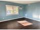 Bedroom featuring hard wood floors, bright blue walls, and a window unit at 624 Folsom S St, St Petersburg, FL 33707