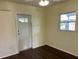 Bedroom featuring wood flooring and one window, complemented by a well-placed door at 624 Folsom S St, St Petersburg, FL 33707