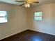 Bedroom with wood flooring, a ceiling fan, and natural light from the two windows at 624 Folsom S St, St Petersburg, FL 33707