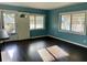 Bright living room featuring wood floors, blue walls and multiple windows allowing lots of natural light at 624 Folsom S St, St Petersburg, FL 33707