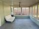 Enclosed sunroom with a ceiling fan and multiple windows for natural light and views of the backyard at 624 Folsom S St, St Petersburg, FL 33707