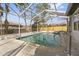 Enclosed pool featuring cool blue waters, a metal ladder, and plenty of space for swimming at 6921 Alken Cir, New Port Richey, FL 34653