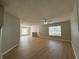 Open living room shows wood floors, neutral paint, and natural light from the large windows at 7145 Waterside Dr, Tampa, FL 33617