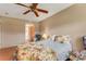 Comfortable bedroom featuring a ceiling fan and tropical-patterned bedspread at 7623 Radcliffe Cir # A101, Port Richey, FL 34668