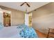 Comfortable bedroom with wood floors and open doors to closet and ensuite bathroom at 7623 Radcliffe Cir # A101, Port Richey, FL 34668