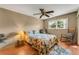 Comfortable bedroom with a ceiling fan, natural light, and hardwood floors at 7623 Radcliffe Cir # A101, Port Richey, FL 34668