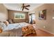 Bedroom with a ceiling fan, access to the sunroom, and tropical-themed decor at 7623 Radcliffe Cir # A101, Port Richey, FL 34668