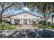 Community clubhouse featuring accessible parking, well-maintained landscaping and a welcoming entrance at 7623 Radcliffe Cir # A101, Port Richey, FL 34668