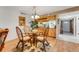 Cozy dining room area featuring wicker furniture set and view to kitchen with breakfast bar at 7623 Radcliffe Cir # A101, Port Richey, FL 34668