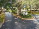 Community entrance to a neighborhood featuring mature landscaping and a gated entry at 7623 Radcliffe Cir # A101, Port Richey, FL 34668