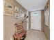 Inviting foyer with colorful decor, tiled floor, and a coat rack at 7623 Radcliffe Cir # A101, Port Richey, FL 34668