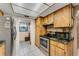 Spacious kitchen featuring wood cabinets, granite countertops, and stainless steel appliances at 7623 Radcliffe Cir # A101, Port Richey, FL 34668