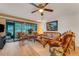 Comfortable living room featuring tropical decor, wicker furniture, and access to an outdoor patio at 7623 Radcliffe Cir # A101, Port Richey, FL 34668