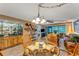 Bright living area with a bar, dining area, and sliding glass doors to the lanai at 7623 Radcliffe Cir # A101, Port Richey, FL 34668