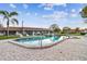 Community pool with brick pavers, lounge chairs, and mature landscaping around the building at 7623 Radcliffe Cir # A101, Port Richey, FL 34668