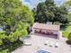 Aerial view of the community pool area featuring a hot tub, lounge chairs, and outdoor dining at 7623 Radcliffe Cir # A101, Port Richey, FL 34668