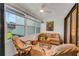 Cozy sunroom featuring a ceiling fan, windows, and casual seating at 7623 Radcliffe Cir # A101, Port Richey, FL 34668