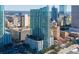 A daytime aerial view of a modern high-rise building with glass windows, nestled in a bustling urban landscape at 777 N Ashley Dr # 3207, Tampa, FL 33602