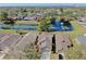 Overhead view of homes next to a serene pond with a fountain and lush greenery at 7853 Bristol Park Dr, Apollo Beach, FL 33572