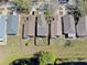 Aerial view of neighborhood home featuring a backyard with a pond and mature trees in a well-maintained community at 7853 Bristol Park Dr, Apollo Beach, FL 33572