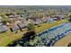 Wide aerial view of homes in neighborhood, pond with lily pads, and lush trees at 7853 Bristol Park Dr, Apollo Beach, FL 33572