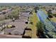 Aerial shot of a community featuring homes bordering a tranquil pond with water lilies at 7853 Bristol Park Dr, Apollo Beach, FL 33572
