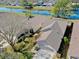 Aerial view of house with a lush backyard, pond and manicured landscaping at 7853 Bristol Park Dr, Apollo Beach, FL 33572
