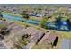 Wide aerial view of homes in neighborhood with pond with lily pads and mature trees at 7853 Bristol Park Dr, Apollo Beach, FL 33572