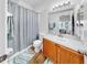 Bathroom featuring a shower and bathtub combination, with wood look vinyl flooring at 7853 Bristol Park Dr, Apollo Beach, FL 33572