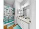Bathroom with decorative seashell shower curtain and integrated sink and vanity at 7853 Bristol Park Dr, Apollo Beach, FL 33572