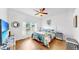 Bright bedroom featuring hardwood floors, ceiling fan, and sunny window at 7853 Bristol Park Dr, Apollo Beach, FL 33572