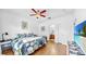 Bright bedroom with ceiling fan, hardwood floors, and ensuite bathroom at 7853 Bristol Park Dr, Apollo Beach, FL 33572