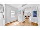 Inviting entryway with wood-look flooring and view to living area beyond archway at 7853 Bristol Park Dr, Apollo Beach, FL 33572