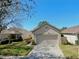 Single story home with a well-manicured lawn and two-car garage at 7853 Bristol Park Dr, Apollo Beach, FL 33572