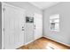 Bright entryway with light hardwood floors, a window and two white paneled doors at 7853 Bristol Park Dr, Apollo Beach, FL 33572