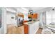 Well-lit kitchen featuring stainless steel appliances, wood cabinets, and a breakfast bar area at 7853 Bristol Park Dr, Apollo Beach, FL 33572