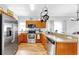 Well-equipped kitchen featuring stainless steel appliances, wood cabinetry, and a functional layout at 7853 Bristol Park Dr, Apollo Beach, FL 33572