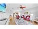 Spacious living room featuring a ceiling fan, an open layout connected to the kitchen, and hardwood floors at 7853 Bristol Park Dr, Apollo Beach, FL 33572