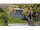 Aerial view of the house showing roof, lawn, landscaping, and driveway at 8501 N Alaska St, Tampa, FL 33604