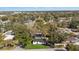 Aerial view of property showcasing mature trees, manicured lawn and landscaping at 8501 N Alaska St, Tampa, FL 33604