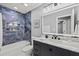Modern bathroom featuring blue marble accent wall, floating vanity, and rainfall shower at 8501 N Alaska St, Tampa, FL 33604