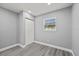 Neutral bedroom with vinyl plank flooring, window, closet with white doors at 8501 N Alaska St, Tampa, FL 33604