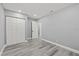 A minimalist bedroom showing the closet, door to the rest of the house, and wood look flooring at 8501 N Alaska St, Tampa, FL 33604