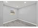 Bright bedroom with neutral walls, recessed lighting, and wood-look vinyl plank flooring at 8501 N Alaska St, Tampa, FL 33604