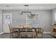 Dining room features a modern light fixture and seating for six, great for hosting dinner parties at 8501 N Alaska St, Tampa, FL 33604