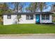 Well maintained home with fresh exterior paint, a manicured lawn, and mature landscaping at 8501 N Alaska St, Tampa, FL 33604